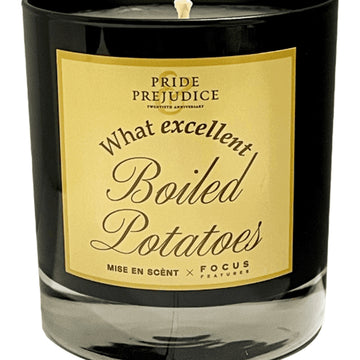 Candle with a label reading 'What excellent Boiled Potatoes' on a white background. Pride & Prejudice movie 20th Anniversary collecible gift item  scented aroma candle Focus Features Academy Museum Store.